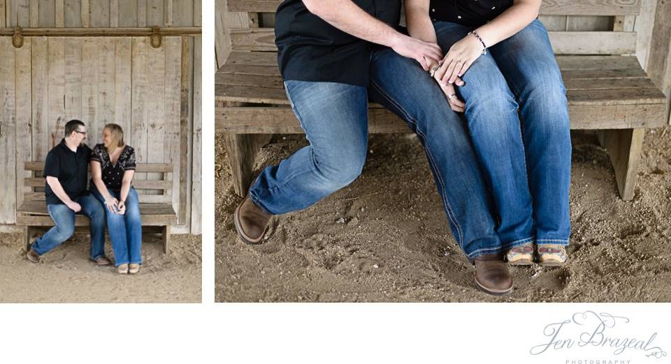 engaged couple laughing in barn