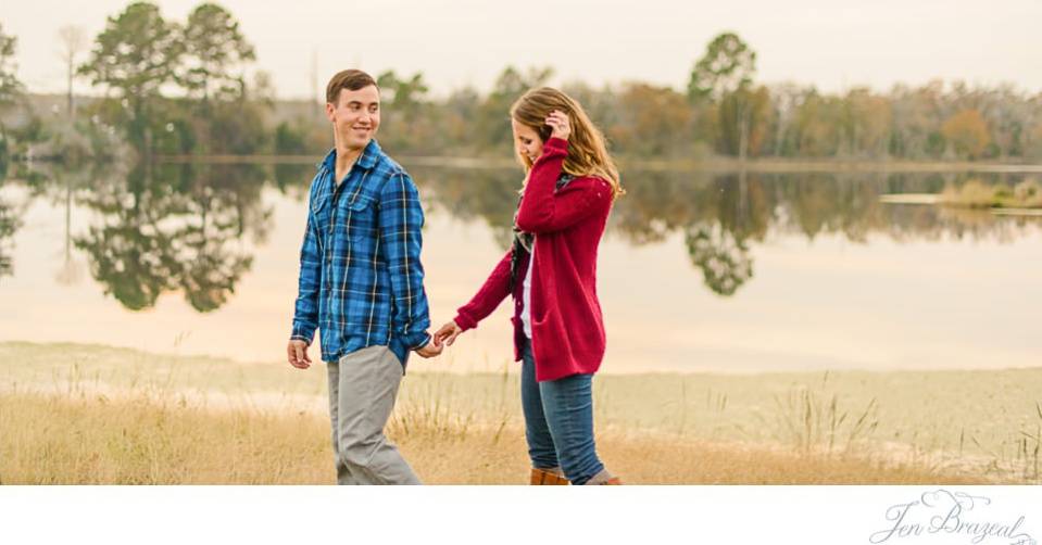 couple walking beside lake